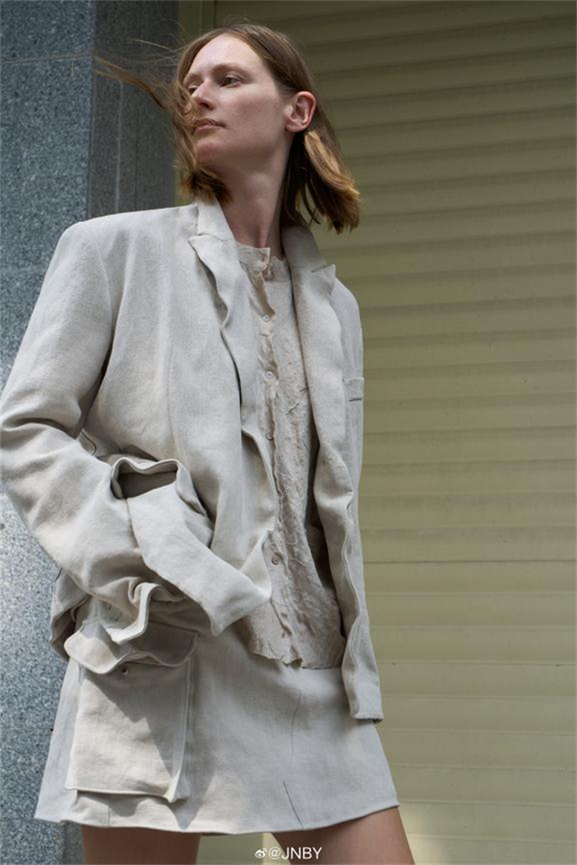 fashion model wearing a casual lightcolored outfit
