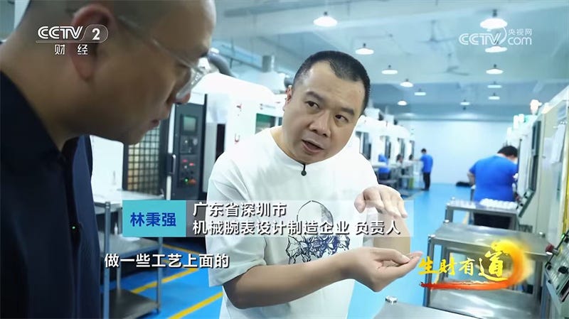 factory setting showcasing machinery and an individual demonstrating a component