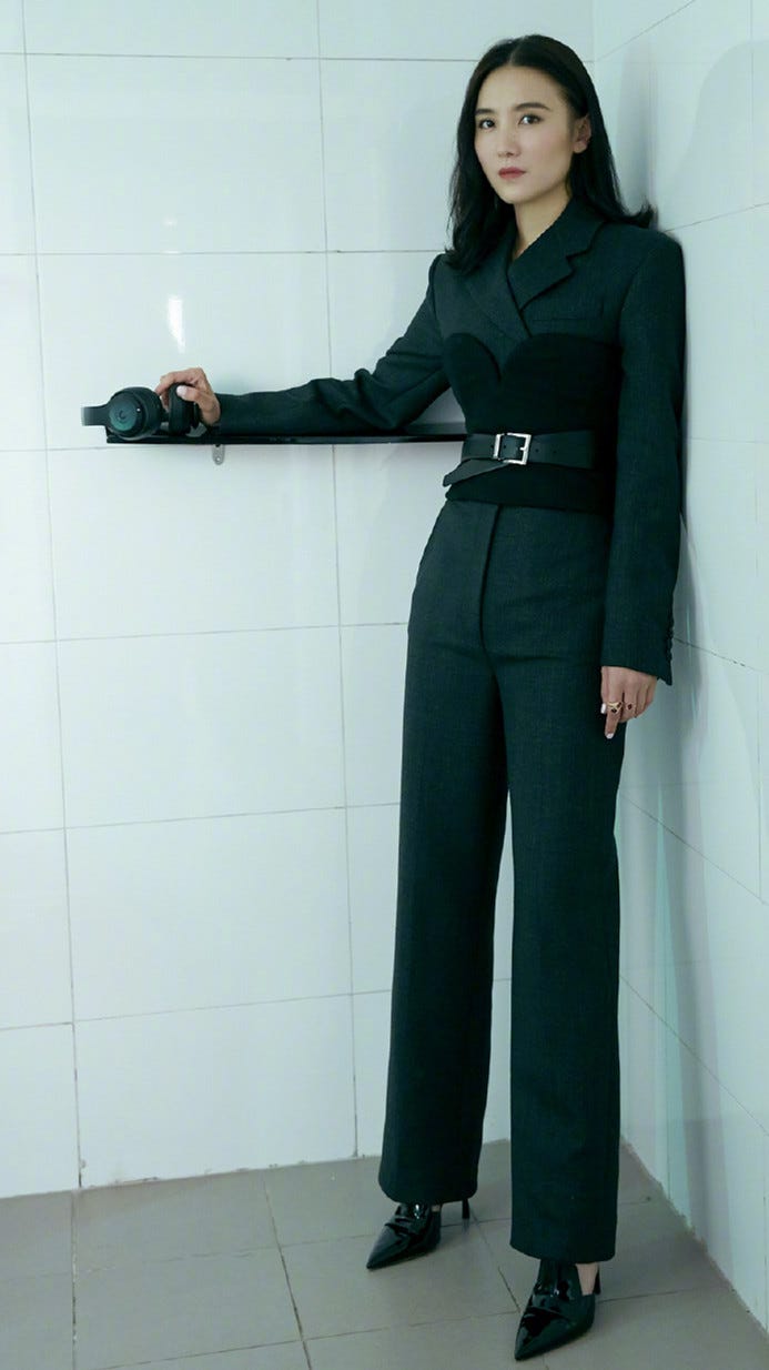 Clothing, Standing, Shoulder, Waist, Suit, Formal wear, Leg, Pantsuit, Joint, Outerwear, 