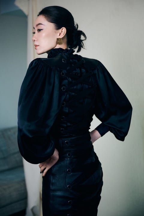 fashionable attire featuring a black outfit with intricate detailing
