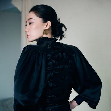 fashionable attire featuring a black outfit with intricate detailing fashionable attire featuring a black outfit with intricate detailing