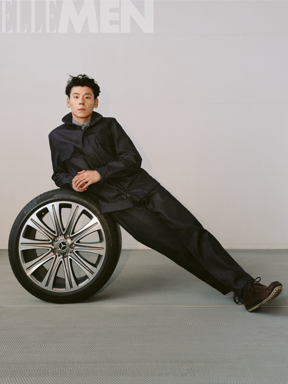 a person is reclining against a wheel on a textured floor