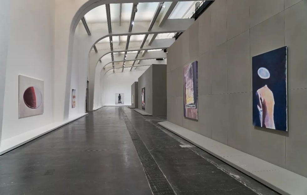 art gallery interior with paintings on display and arched ceiling