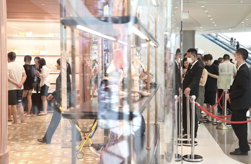 luxury boutique featuring shoppers and security personnel