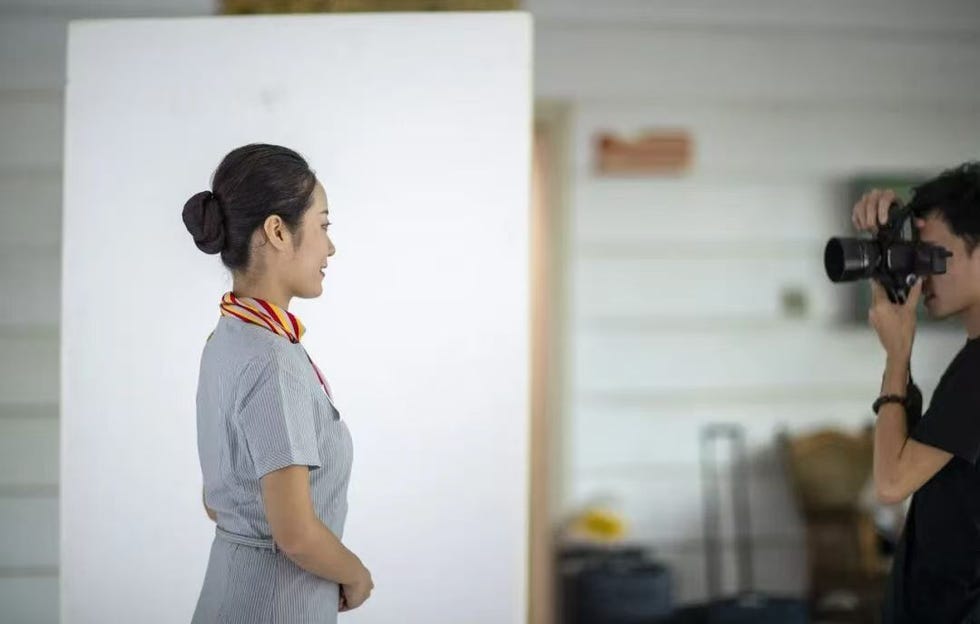 a person posing for a photograph in a studio setting