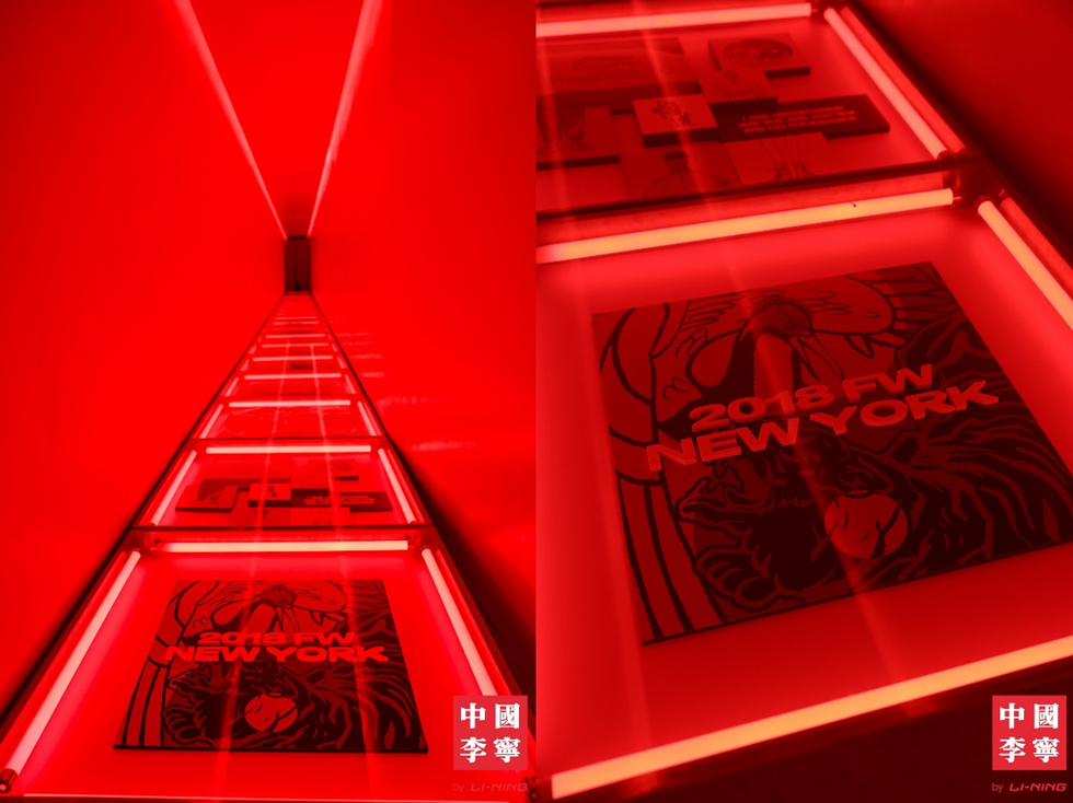a red wall with a painting on it