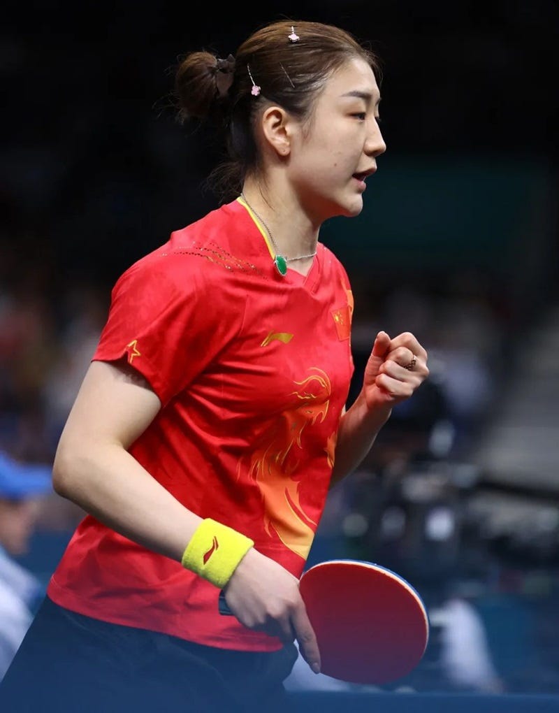 a woman holding a red ball