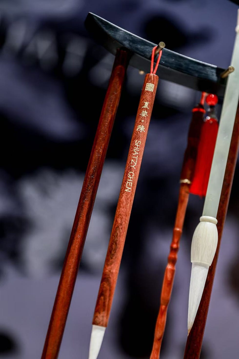 chinese calligraphy brushes and tools displayed on a stand