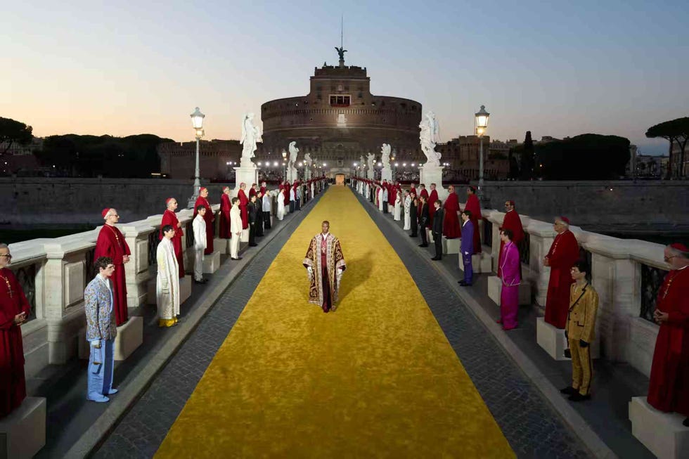 ceremonial event with a golden carpet and clergy members