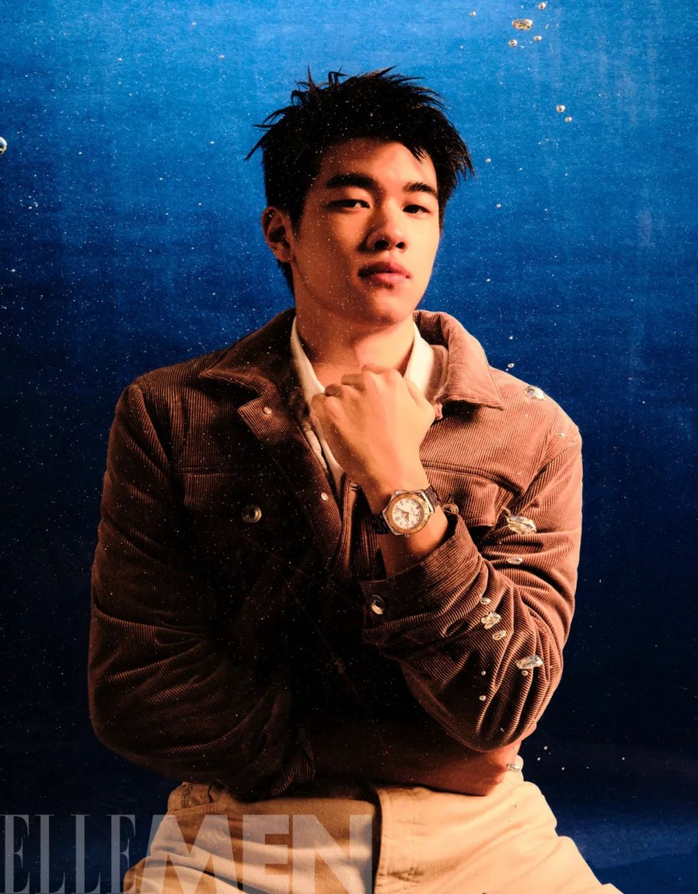 underwater portrait of an individual dressed in a brown corduroy jacket
