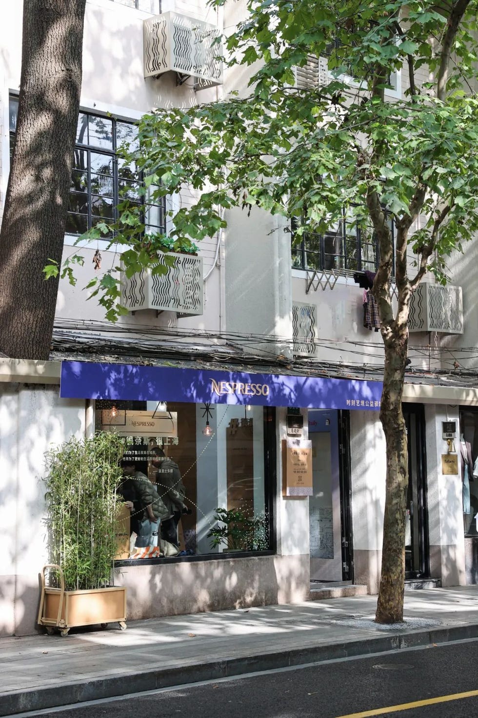 nespresso storefront with outdoor seating and greenery