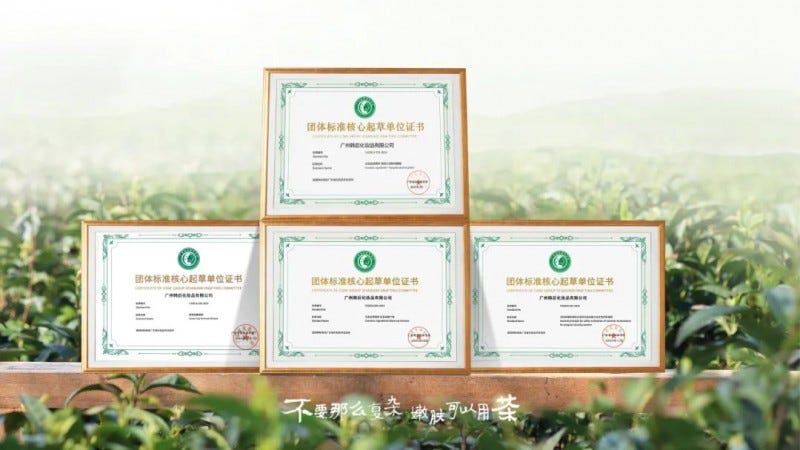 certificates displayed on a surface with a background of green foliage