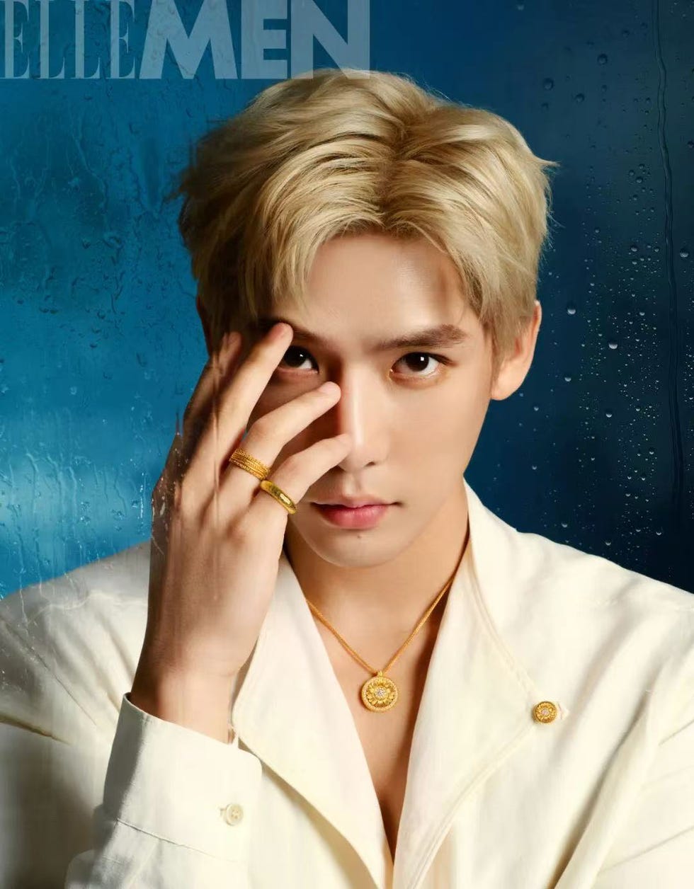 fashion editorial featuring a stylish individual in a white outfit with a golden necklace