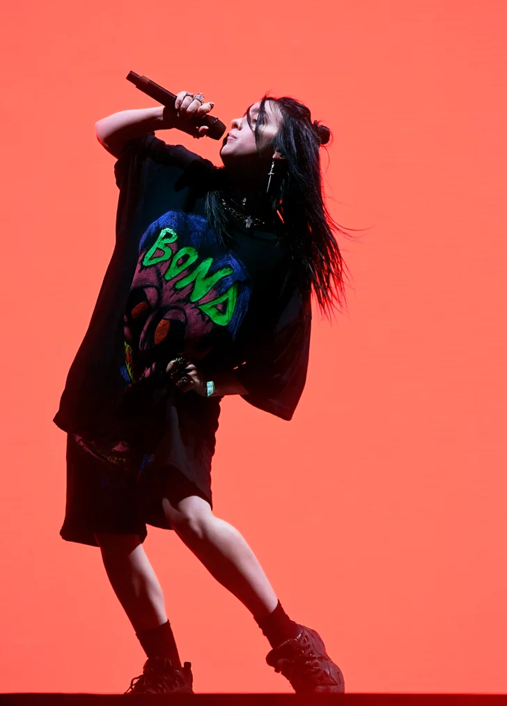 a woman singing into a microphone