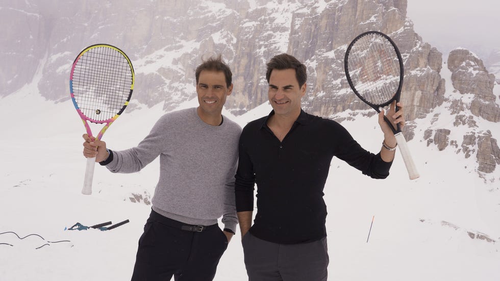 two men holding tennis rackets