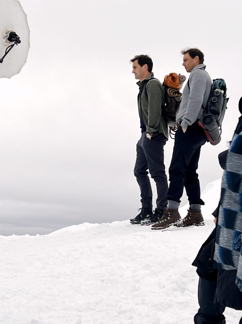 a group of men standing on a snowy hill