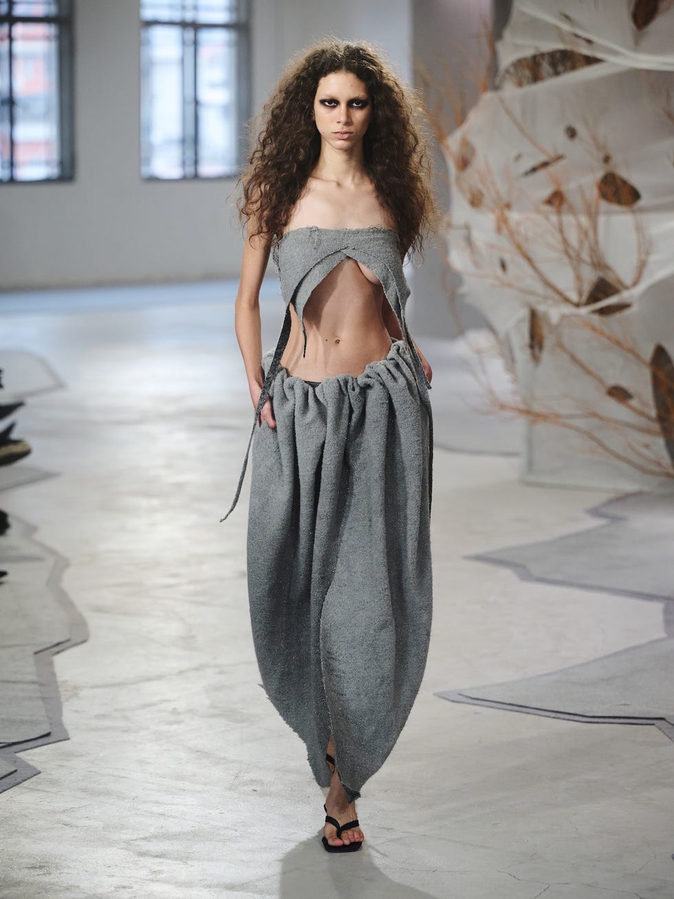 fashion model showcasing a unique garment in an urban setting
