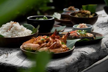 assorted seafood dishes served on wooden plates with rice