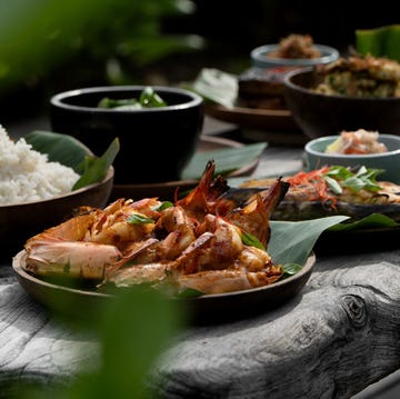 assorted seafood dishes served on wooden plates with rice assorted seafood dishes served on wooden plates with rice