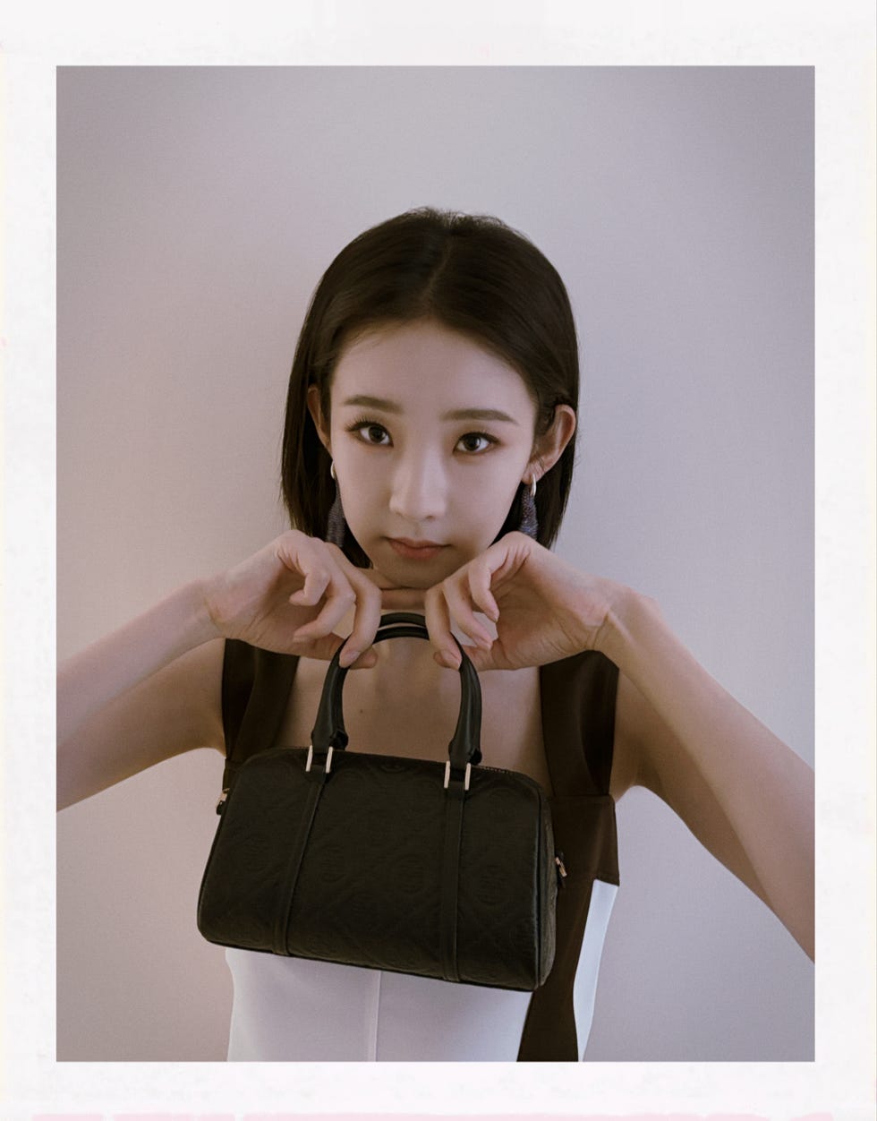 model showcasing a stylish black handbag