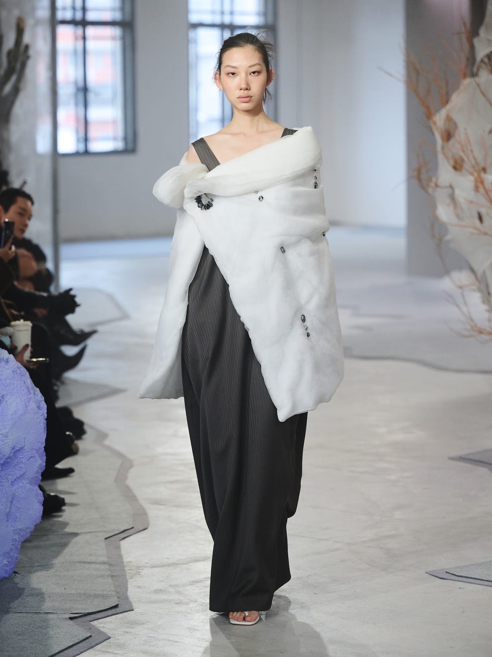 fashion model showcases modern clothing in a runway setting