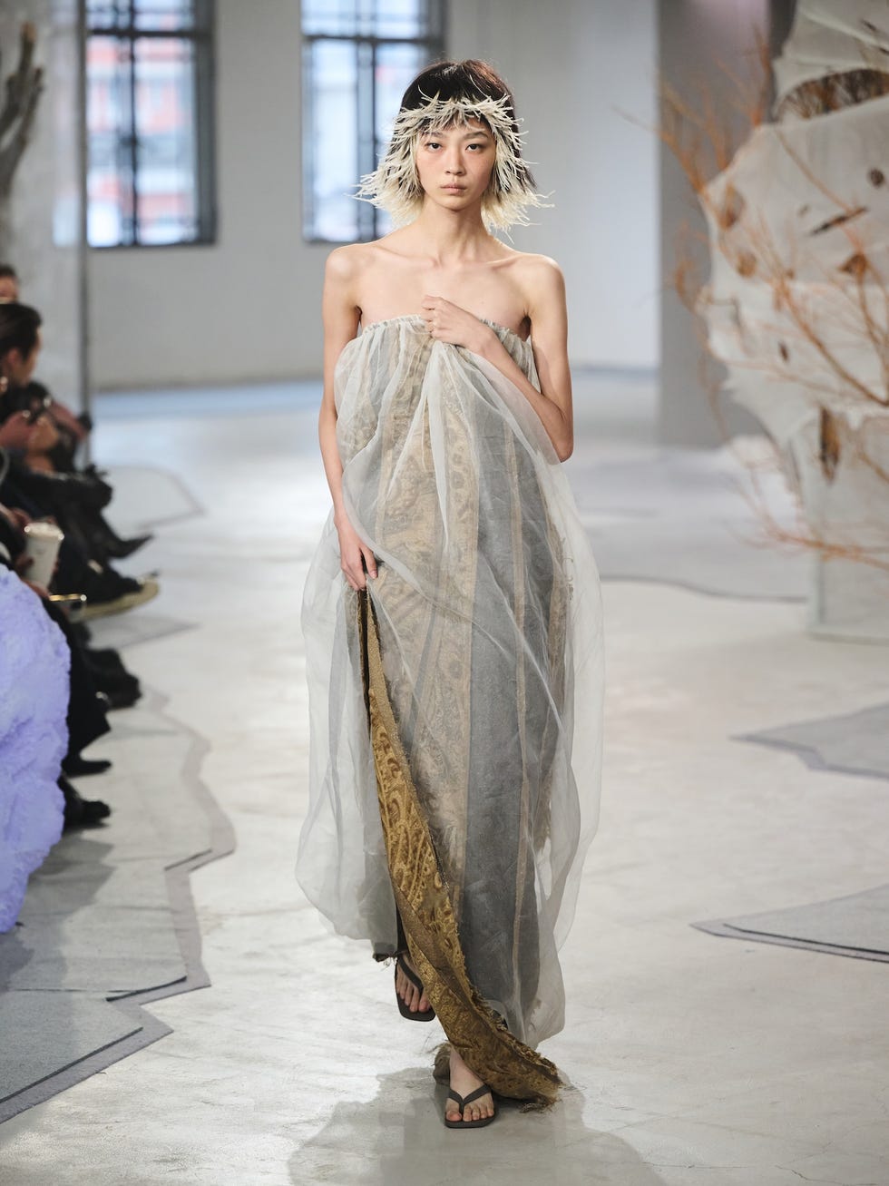 fashion model showcasing a unique clothing design on a runway