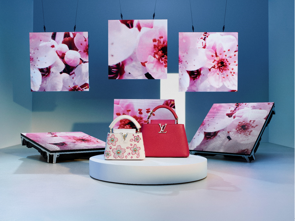 showcase of luxury handbags with floral displays
