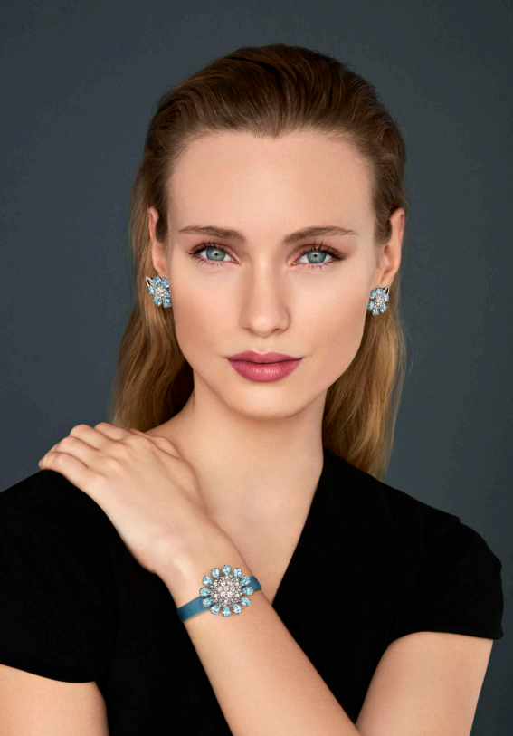 model wearing jewelry including earrings and a bracelet