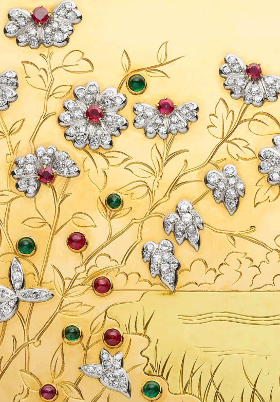 decorative golden surface adorned with floral motifs made from gemstones