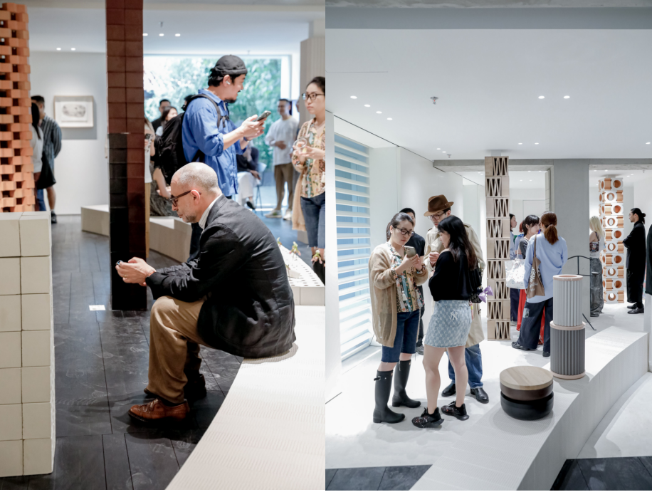 interior of an exhibition space with visitors engaging with displays