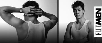 black and white image of a man showing his back while wearing a tank top with a watch on his left wrist