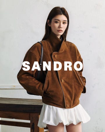fashionable model showcasing a stylish brown jacket and a white skirt