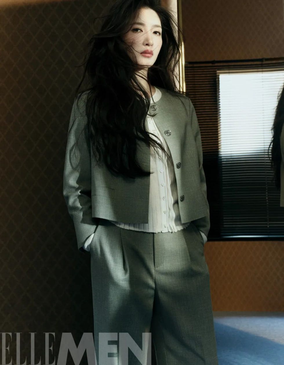 model dressed in a modern suit within a stylish interior