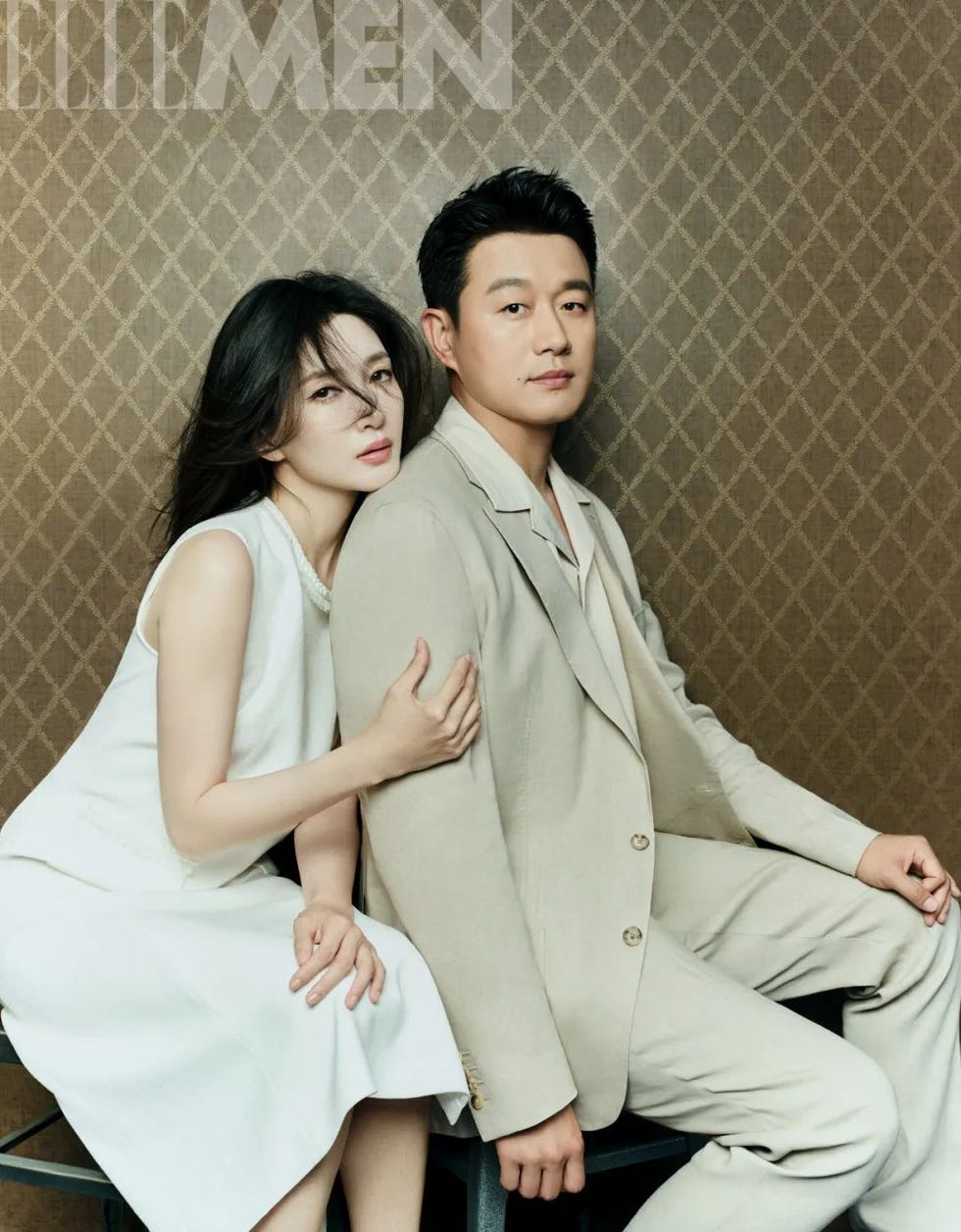 a couple poses closely together in a stylish setting