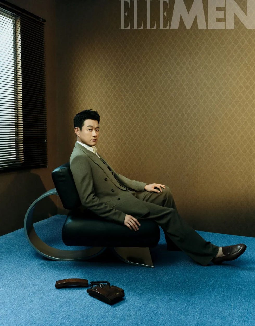 a welldressed individual seated in a modern chair