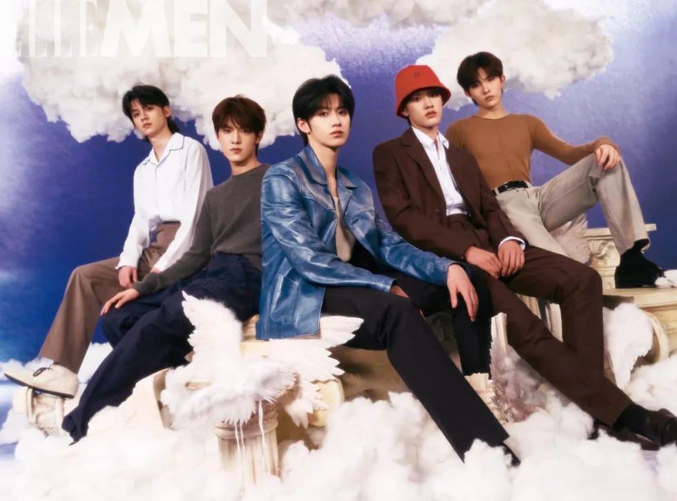 group of five individuals posed fashionably on a cloudlike backdrop suggesting a dreamy theme