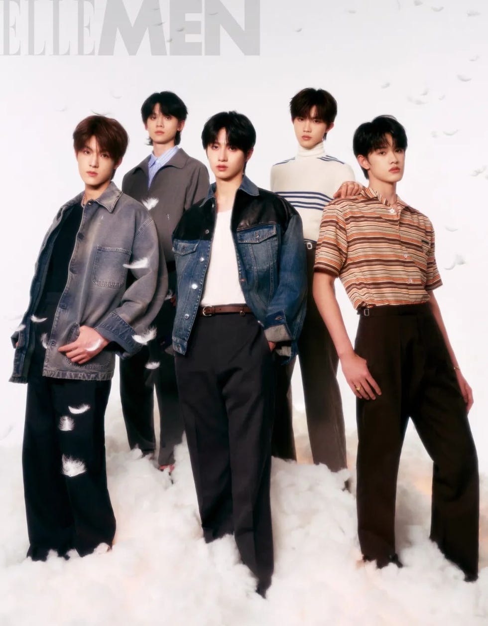 group of five individuals posing against a soft background