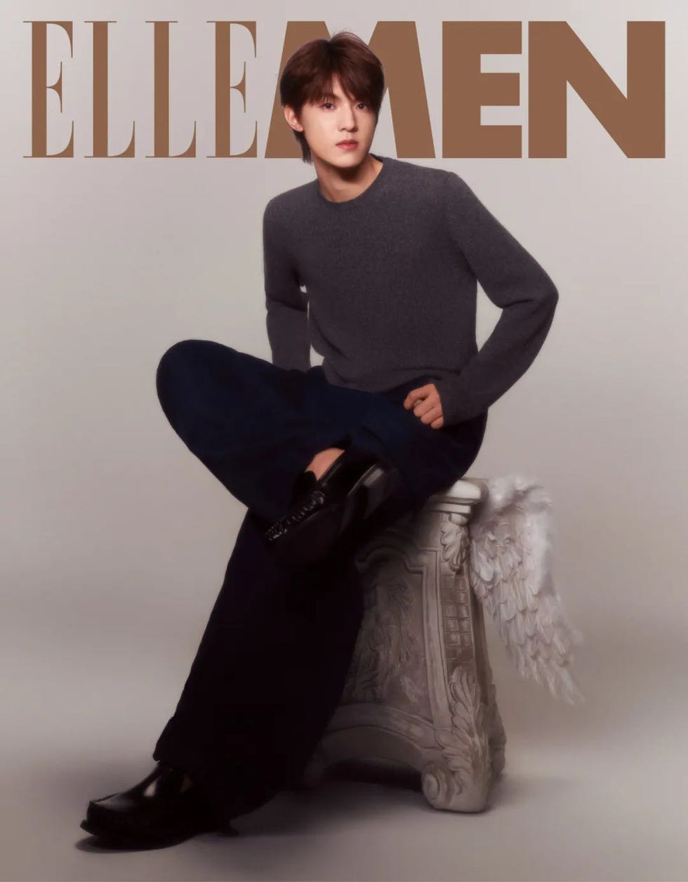 fashion editorial featuring a seated male model styled for a magazine cover