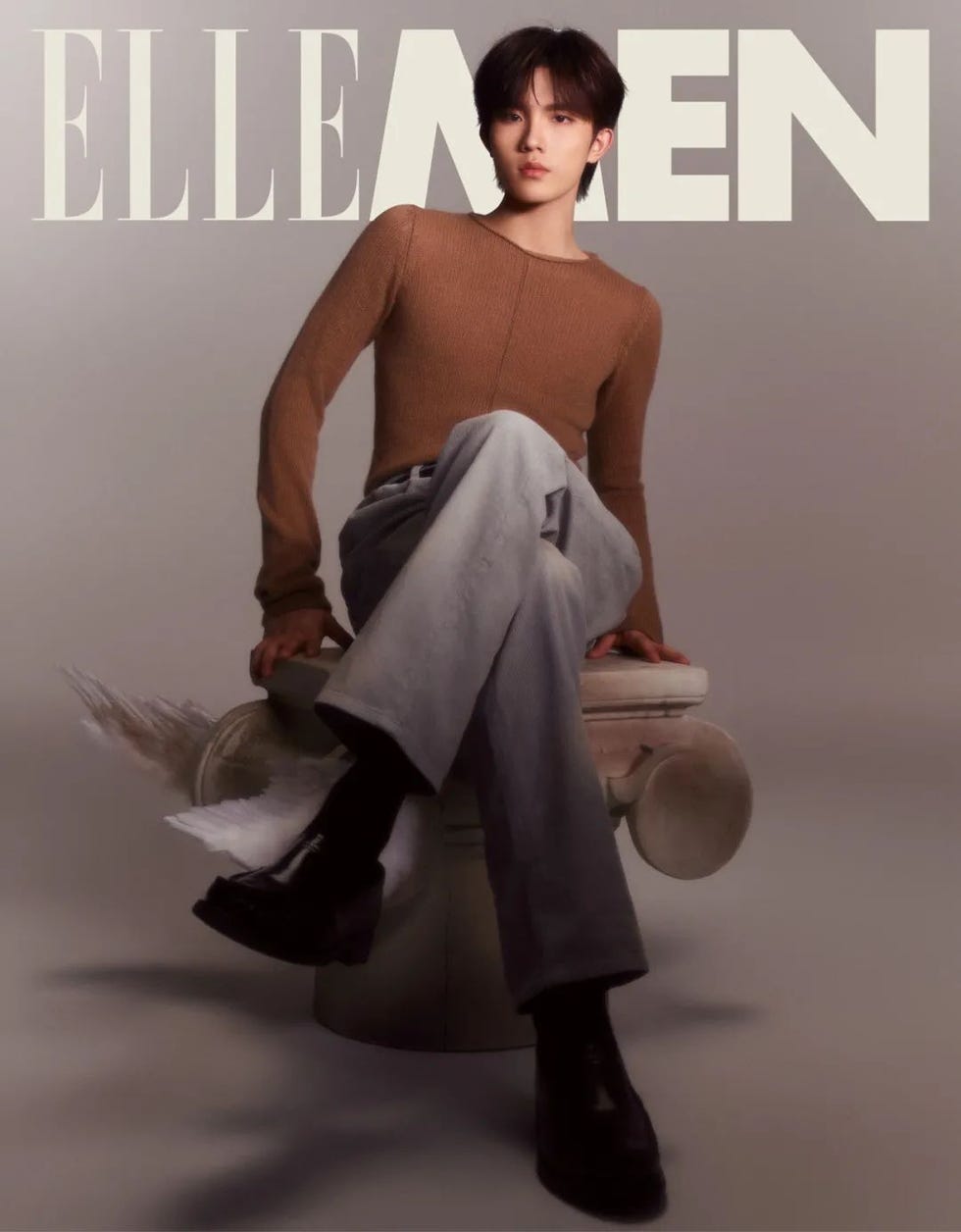 fashion magazine cover featuring a seated individual