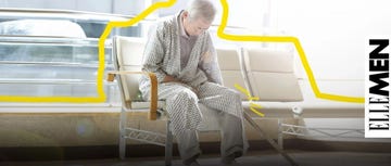 an elderly person sitting on a bench with a cane