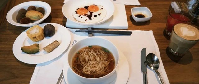 a breakfast spread featuring various dishes and beverages