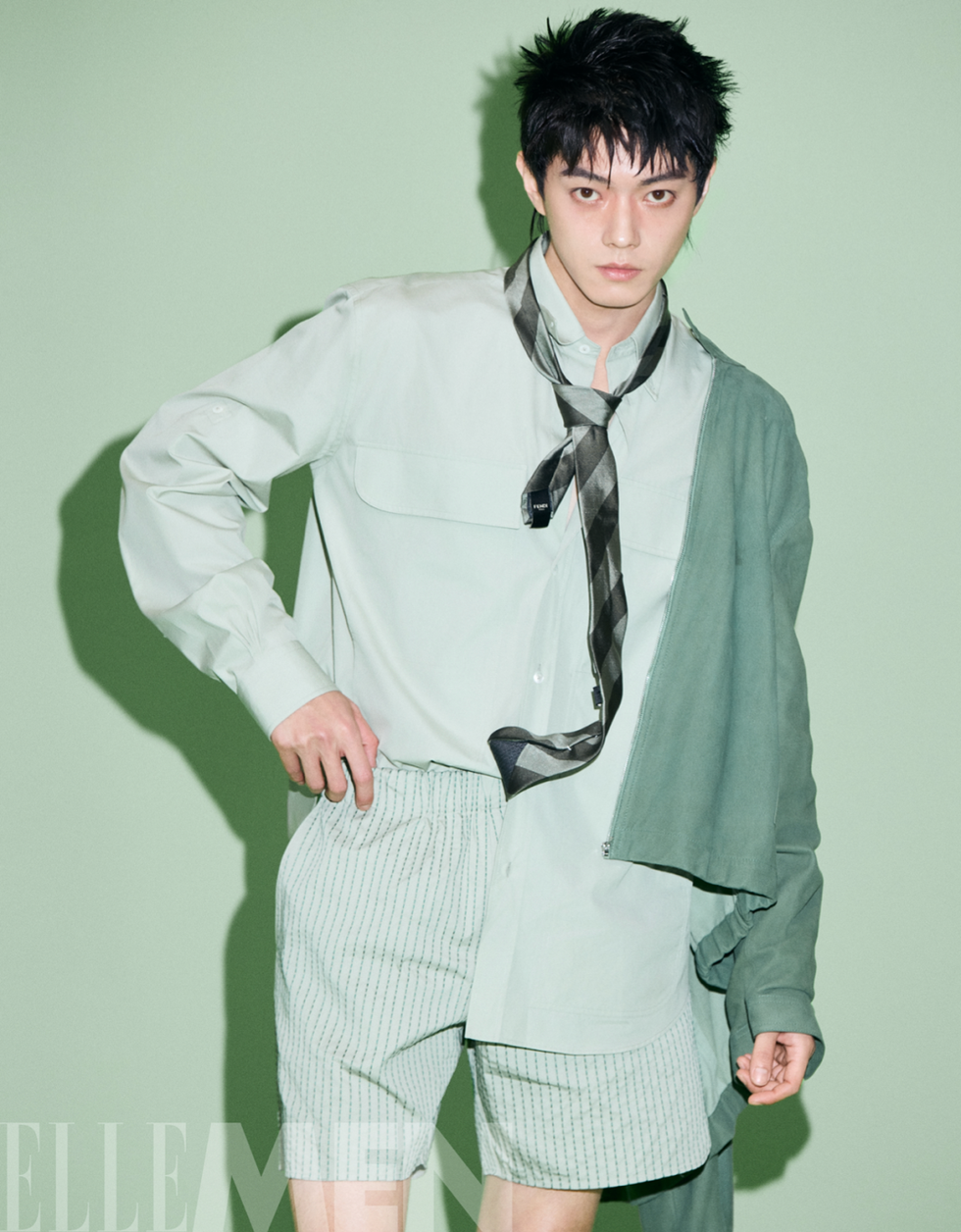 fashion model wearing layered outfit with a mix of shirts and shorts