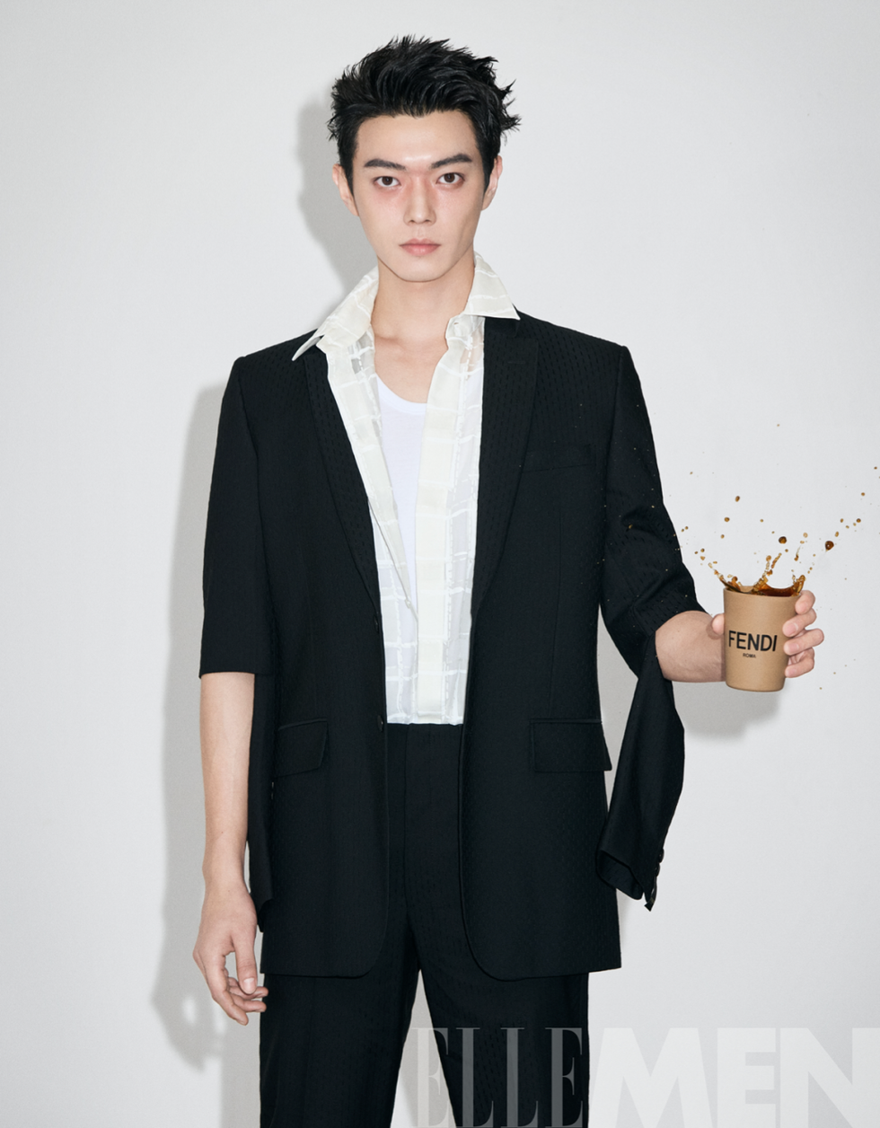 a stylish figure holding a branded cup with liquid splashing out