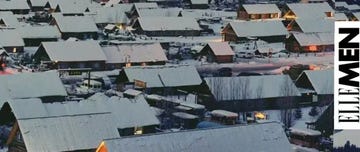 snowcovered village with wooden houses at night
