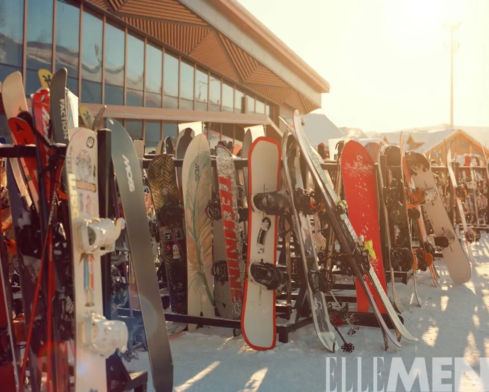 display of various snowboards and skis in a winter sports setting