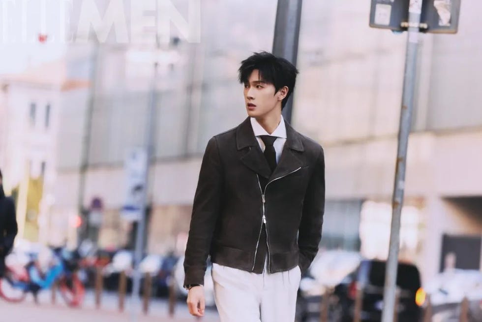 a person walking on a city street wearing a stylish outfit