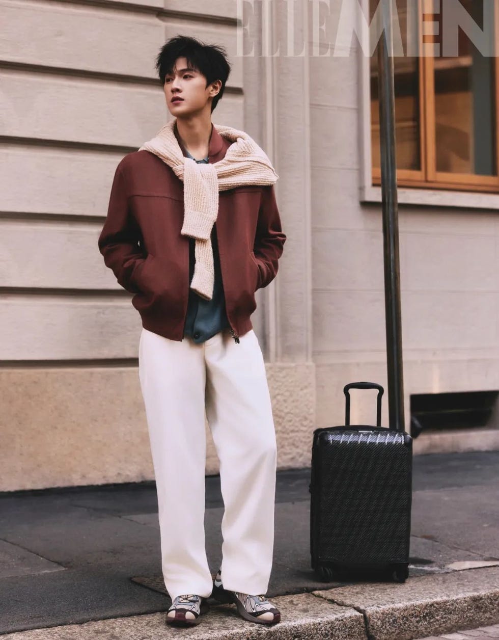male figure in stylish outfit with a suitcase
