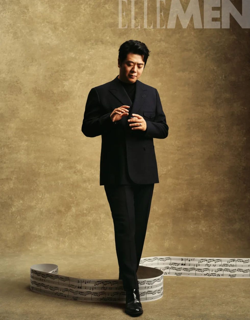 stylish man posing with a musical score in a creative setup