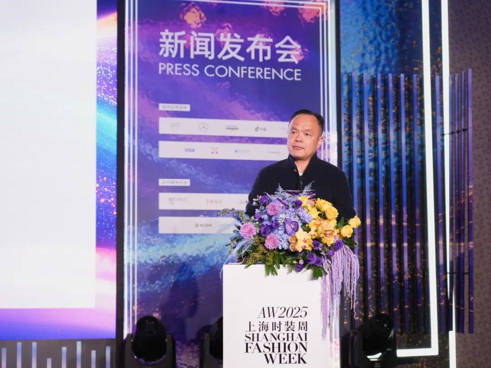 press conference setting featuring a floral arrangement