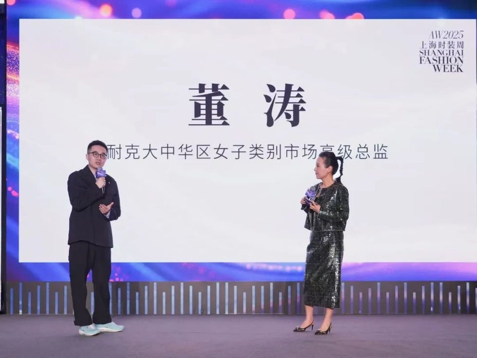 presentation at shanghai fashion week featuring a speaker and an award recipient